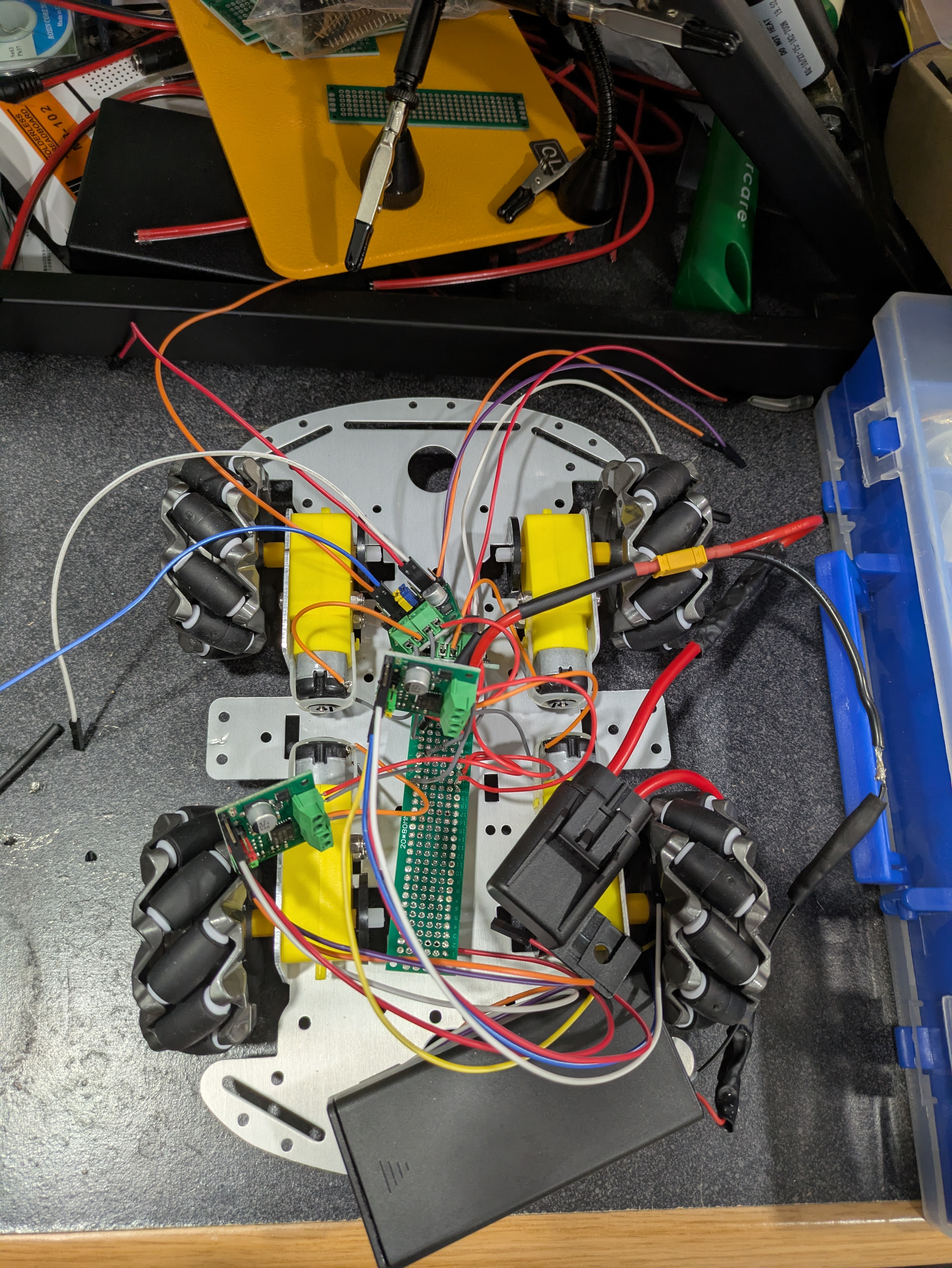 Top-down view of the rover chassis with four mecanum wheels, motors, and perfboard
